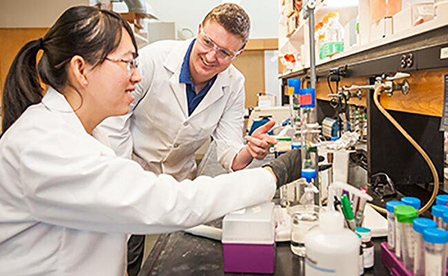 Professor in lab working with doctoral student