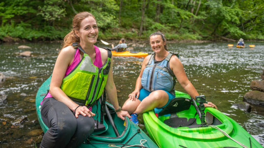 Katie Liming, M.S. ’22, and Stephanie Covino, M.S./ES&P ’15, on the Blackstone River.