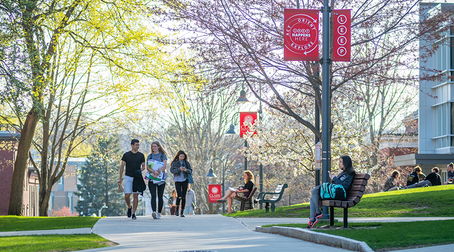 students walking down campus green