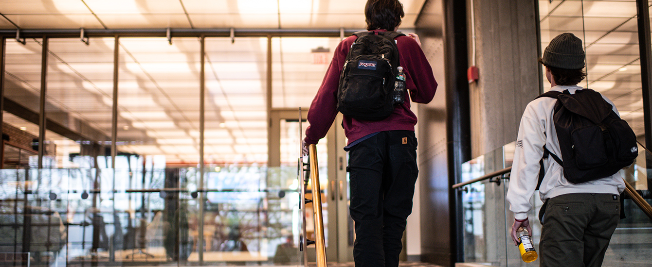 Bachelor's to Master's Program hero with two students walking up stairs in library