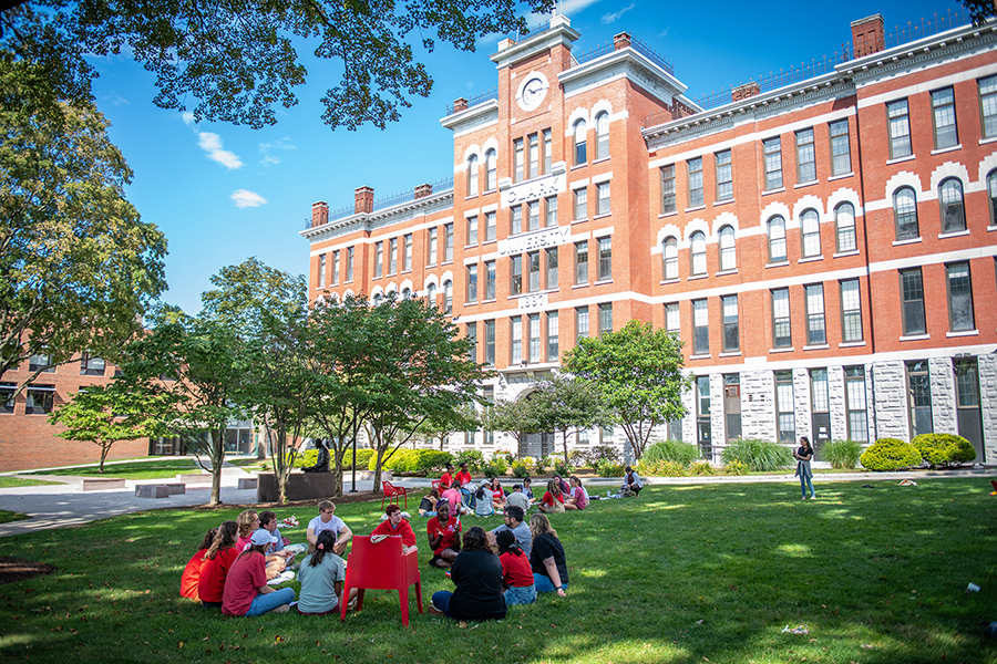 students sitting on the campus green