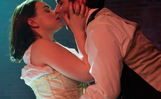 theatre arts with two students kissing on stage