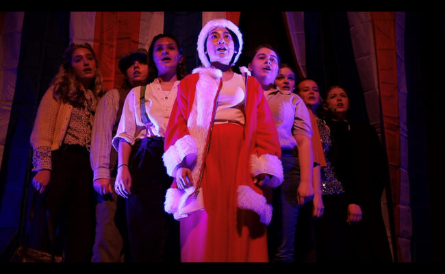 theatre arts - students performing on stage with santa outfit