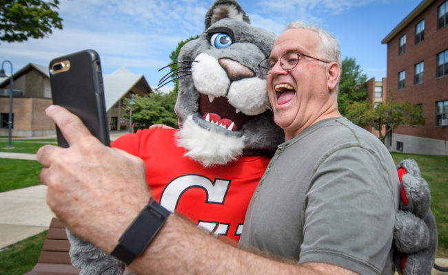 dad taking selfie with mascot