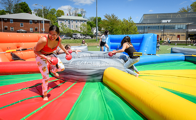students in blowup amusement slide