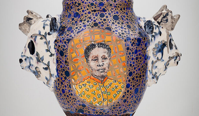 Vase with woman's face painted on it