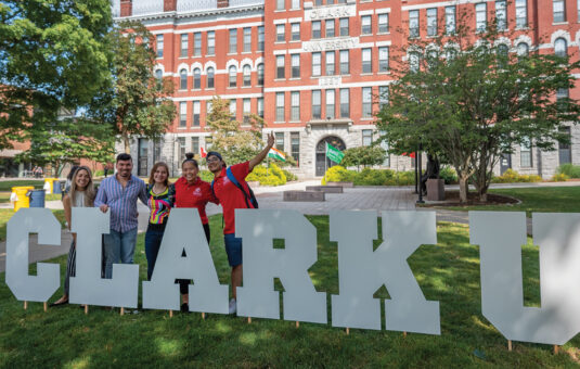 Students in front of #ClarkU sign
