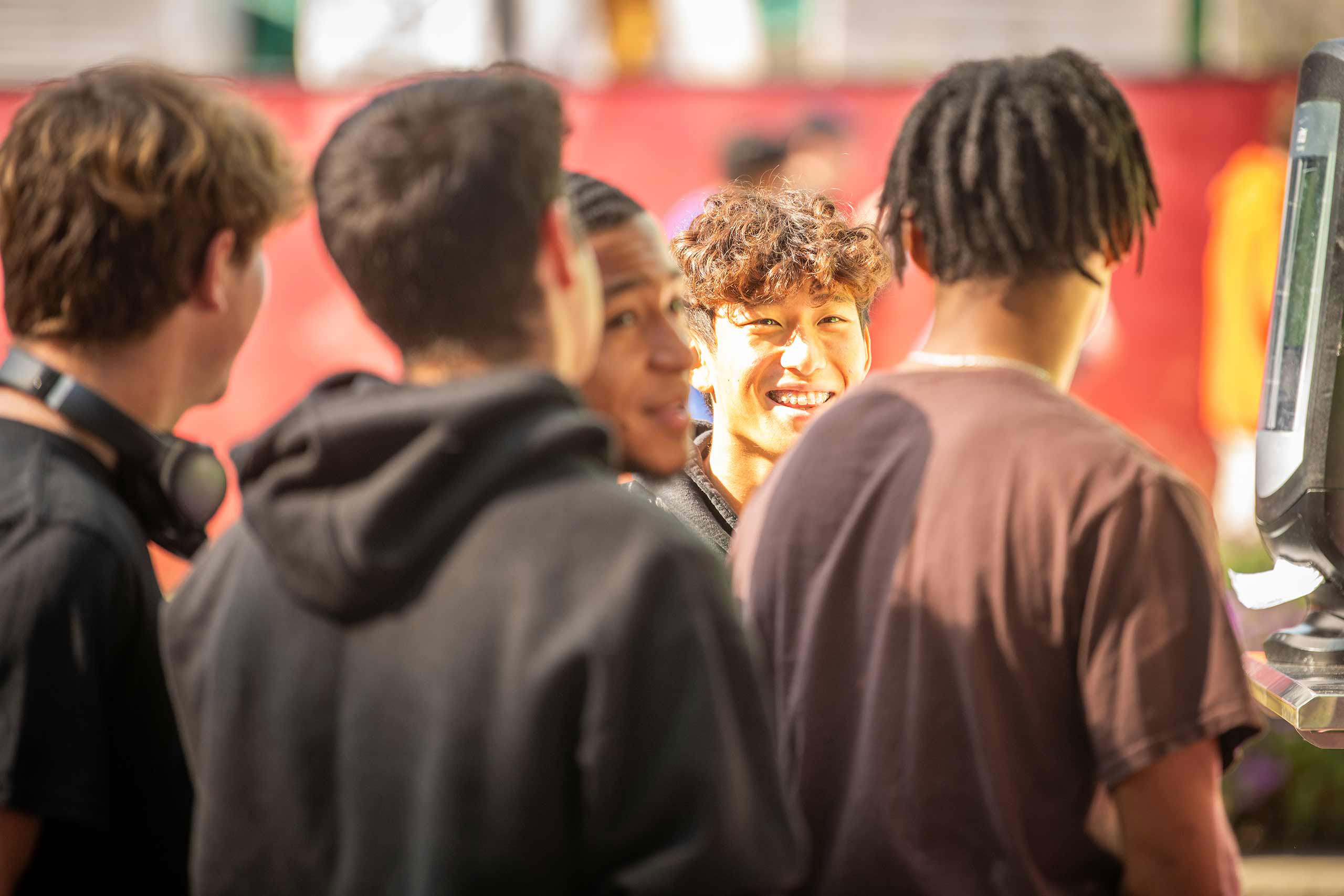 A group of students laughing together at a campus mental wellness event.