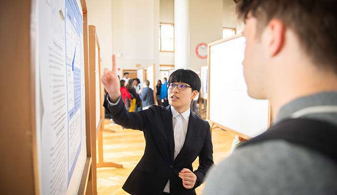 A student explains their original research at ClarkFEST, spring 2024