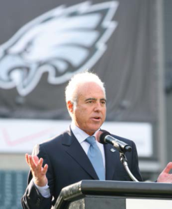Jeff Lurie standing at podium speaking to crowd