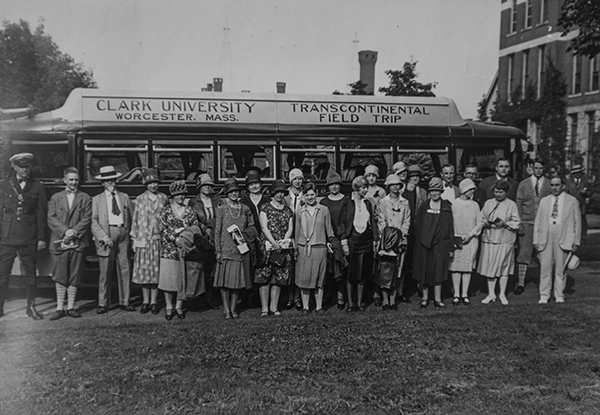 Clark University geography students and faculty in front of bus for Transcontinental road trip in 1925