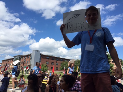 Peer Adviser Tyler Terriault looks for his group in front of Atwood Hall