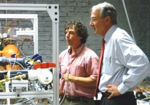 Physics Prof. Charles Agosta shows Jeffrey Simon, MA Recovery & Reinvestment Office director, Machflow technology under development.