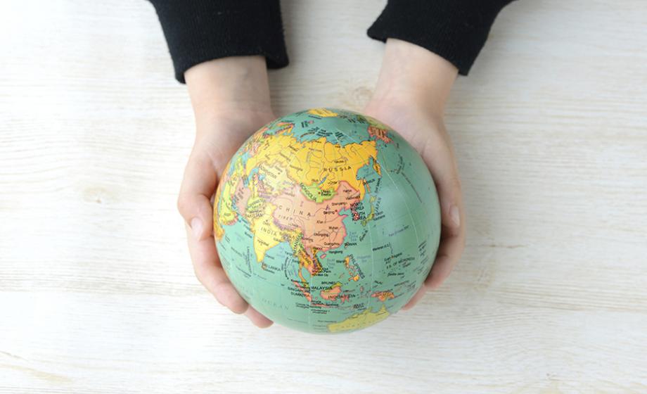 small globe in 2 hands photo