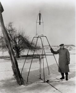 Robert Goddard with a rocket and frame in Massachusetts