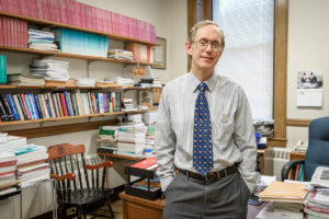 Wayne Gray standing in his office at Clark University