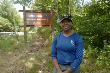 Olivia Barksdale next to sign for Patoka River National Wildlife Refuge