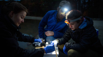 Linnea Menin takes samples at Walden Pond with Emily Dart and Professor Ahlgren