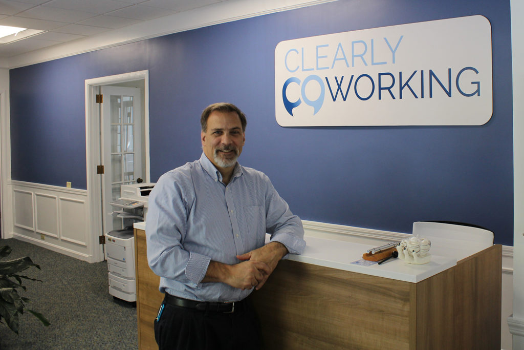 Robert DelMastro at front desk of Clearly Coworking