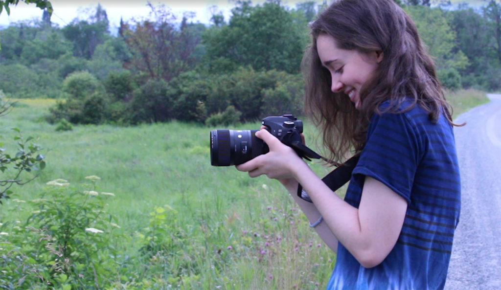 Julianna Lugg with her camera during her tour of New England's six smallest communities