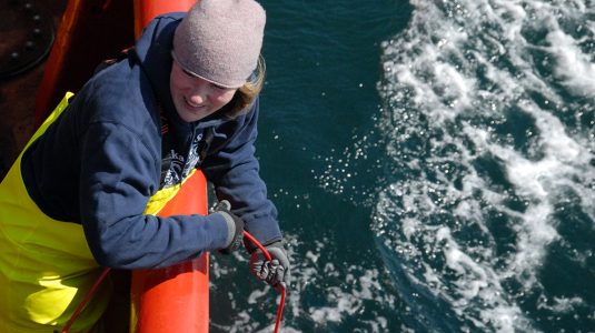 3) Karen Frey deploys instruments into the Bering Sea that measure the transmittance of light through seawater onboard the Canadian Coast Guard Ship Sir Wilfrid Laurier in July 2019