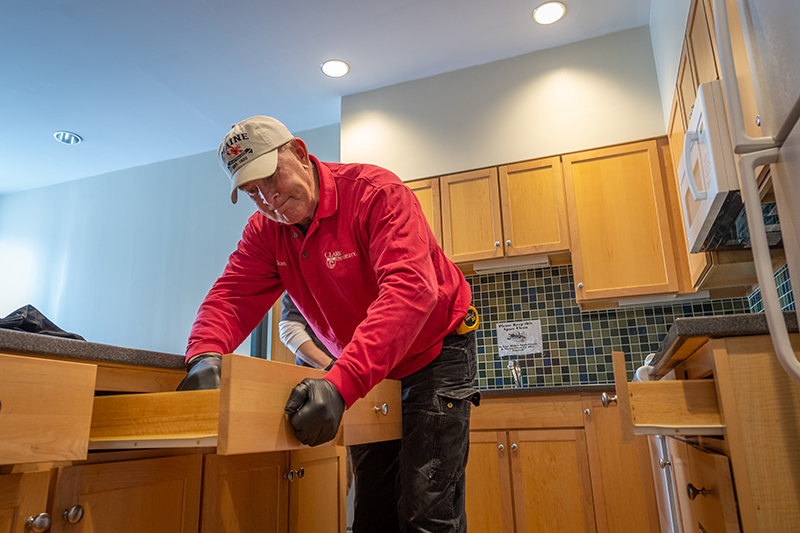 Facilities worker cleans a suite in Blackstone Hall