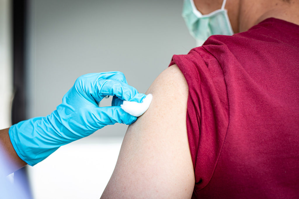Person preparing to receive flu vaccine 