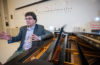 Professor Ben Korstvedt sits at the piano