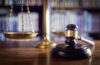 Judge's gavel, scales of justice, and law books in court
