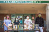 University Park Campus School teacher (and Clark alumna) Helen Ward, Claremont Academy junior Ailany Rivas, UPCS senior Fernando Matos, and Clark professor Raphael Rogers outside the Claremont Academy with some of the books they used in their research on how slavery is represented in schools and children’s book publishing.