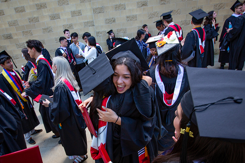 Clark University students hug after the 2021 Commencement ceremony.