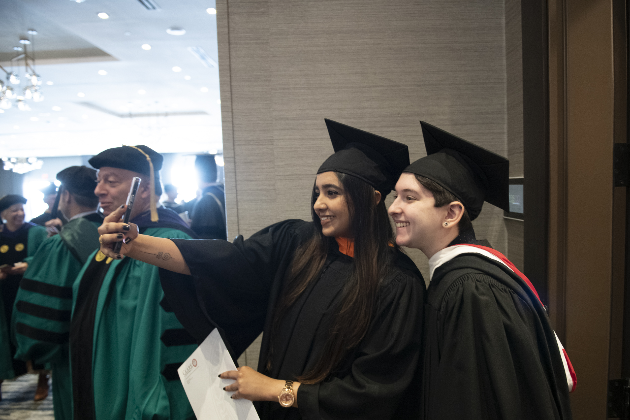 Clark students Rena Zisser ’24 and Aditi Singh, M.S. ’22 take a selfie before the inauguration ceremony