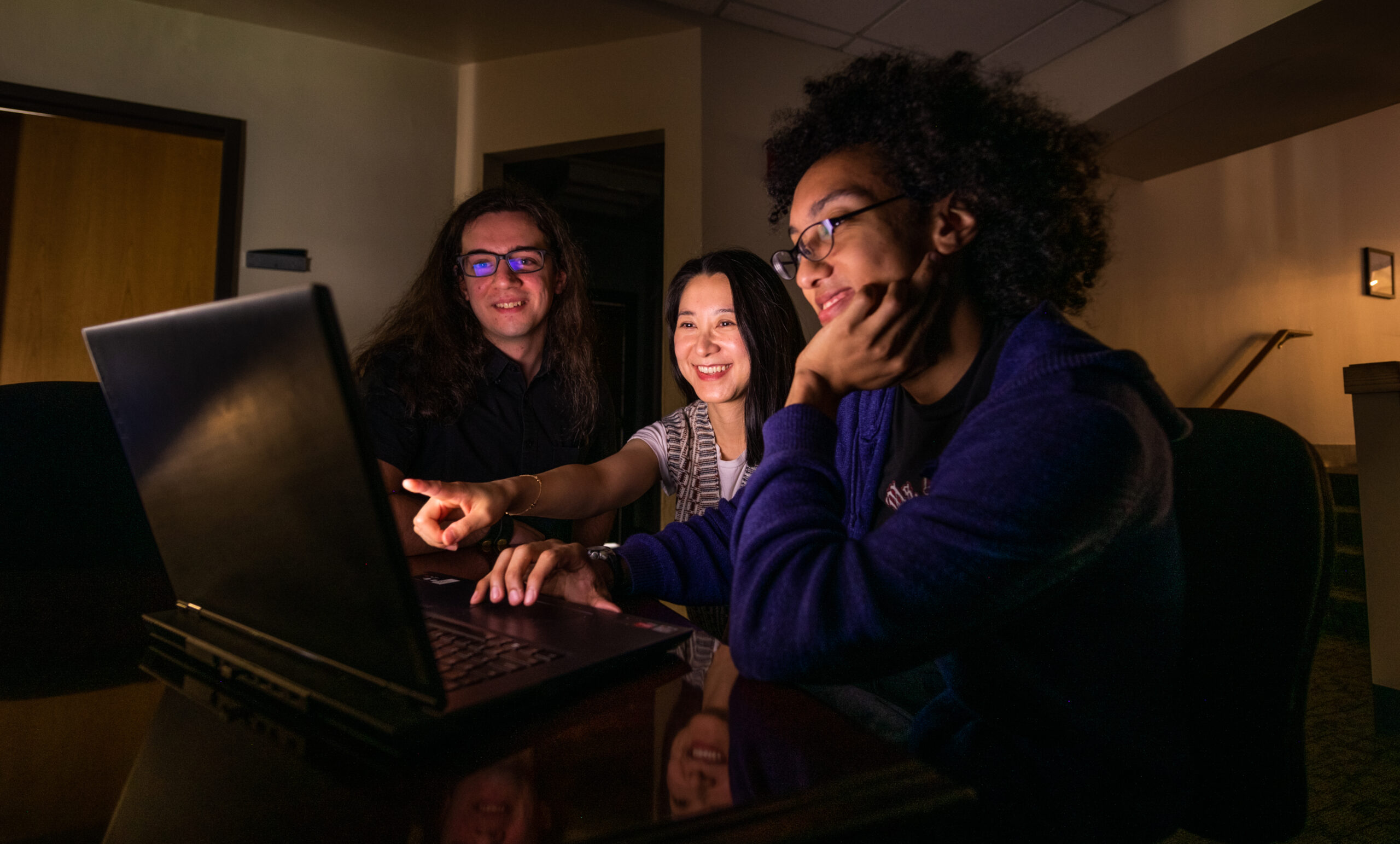 three students at laptop