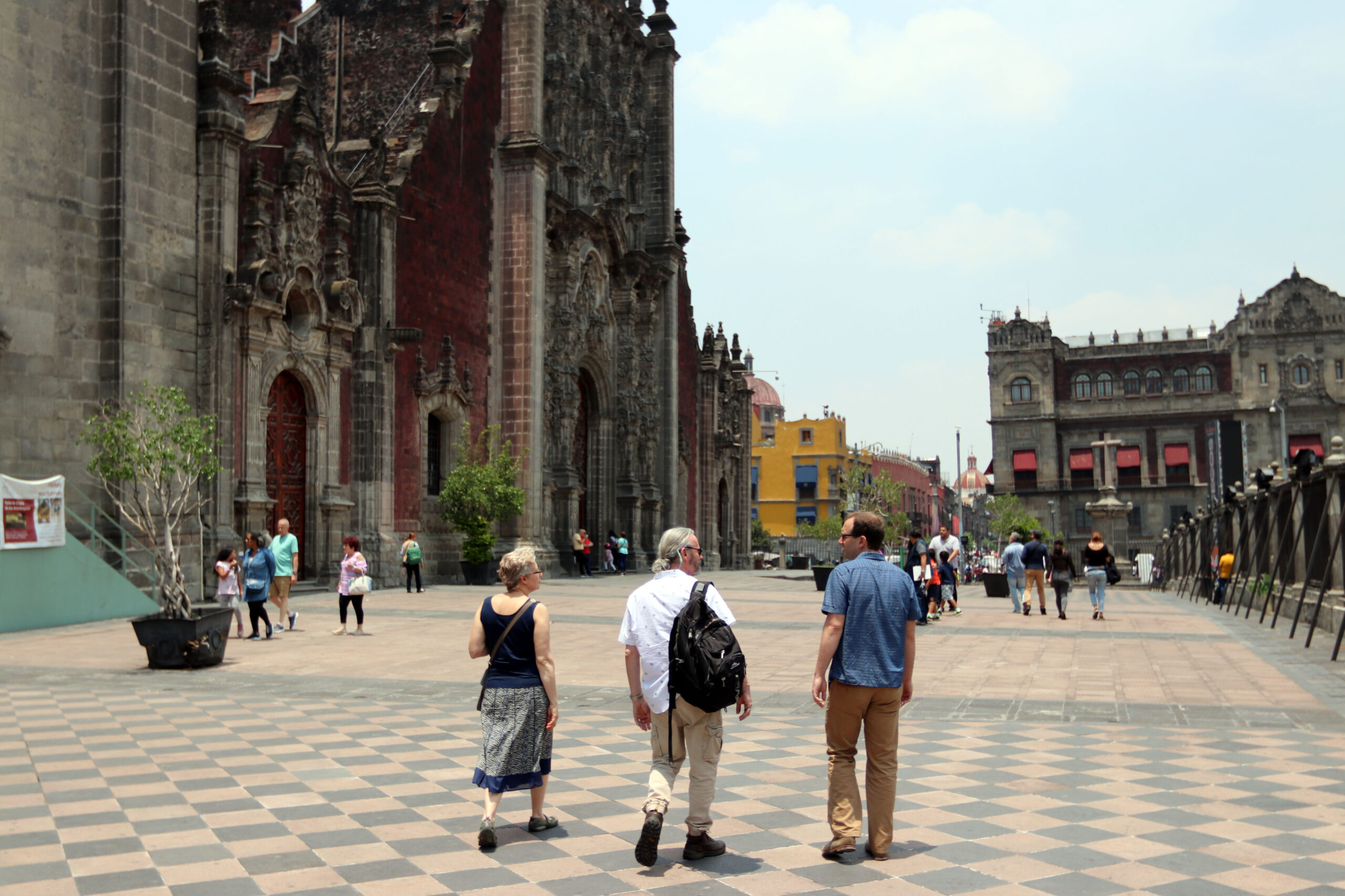 Professors Yelena Ogneva-Himmelberger, Tim Downs, and Morgan Ruelle stroll in front of the Mexico City Metropolitan Cathedral