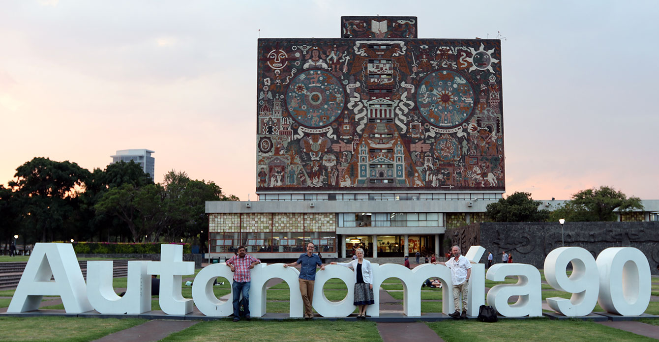 Researchers standing in front of UNAM building