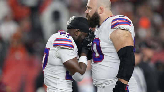Above: Tre’Davious White and Mitch Morse of the Buffalo Bills react to teammate Damar Hamlin’s collapse during the Jan. 2 game against the Cincinnati Bengals.