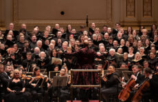 Cailin Marcen Manson conducts a combined choir including the Clark University Choir in a performance of Verdi's Requiem at Carnegie Hall.