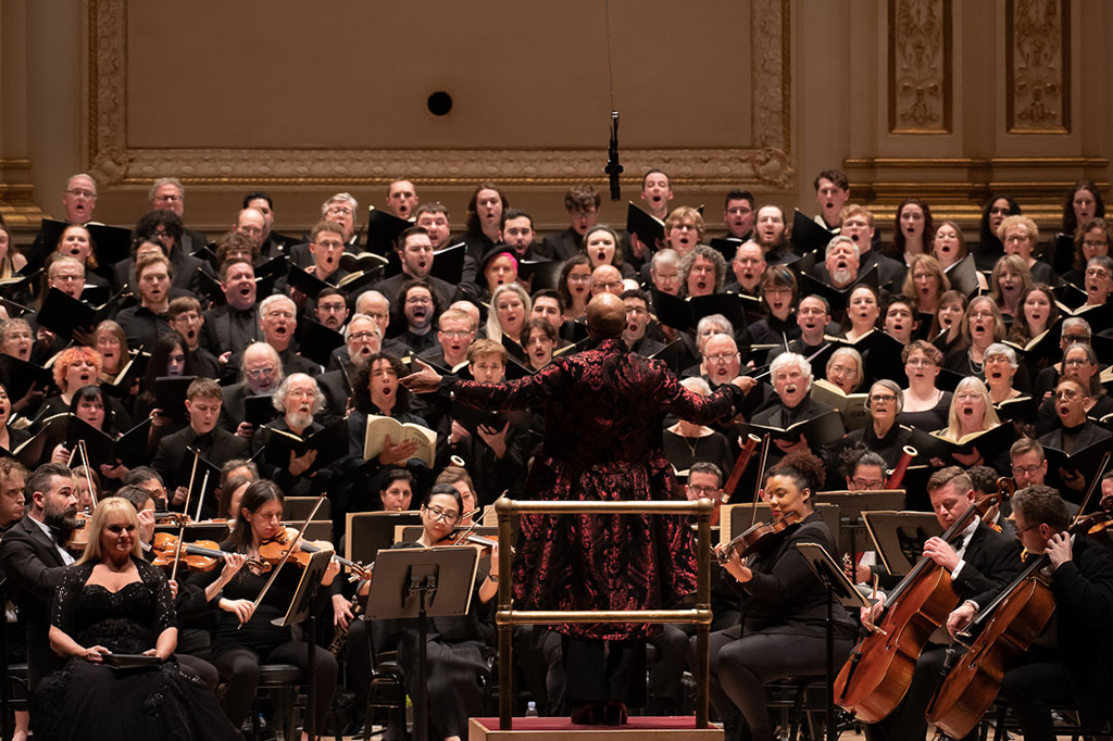 Cailin Marcen Manson conducts a combined choir including the Clark University Choir in a performance of Verdi's Requiem at Carnegie Hall. 