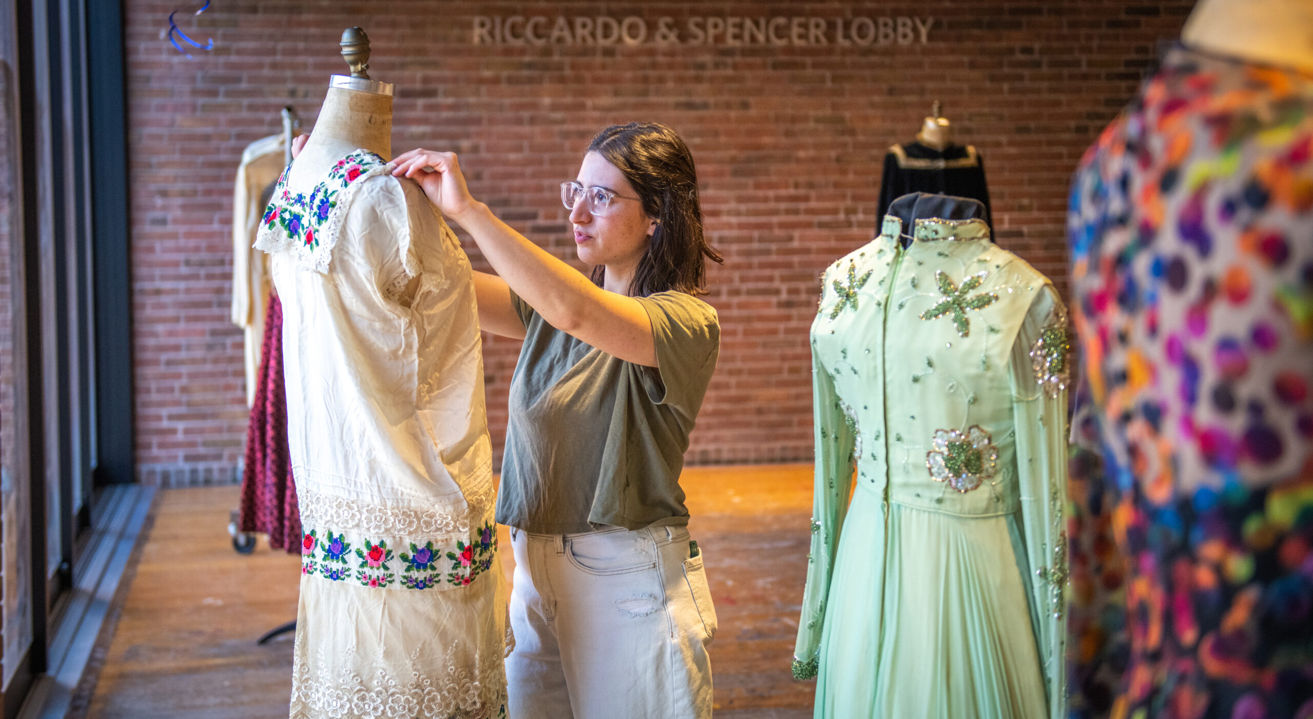 Maia Snyder '23, M.A '24, arranges a historic fashion exhibit on campus.