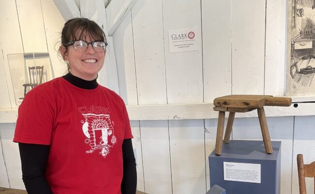 Maire O'Donnell ’23 with a historic stool at Old Sturbridge Village.