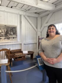 Hannah Friend ’23, M.A. ’24, with a historic bench at Old Sturbridge Village. 