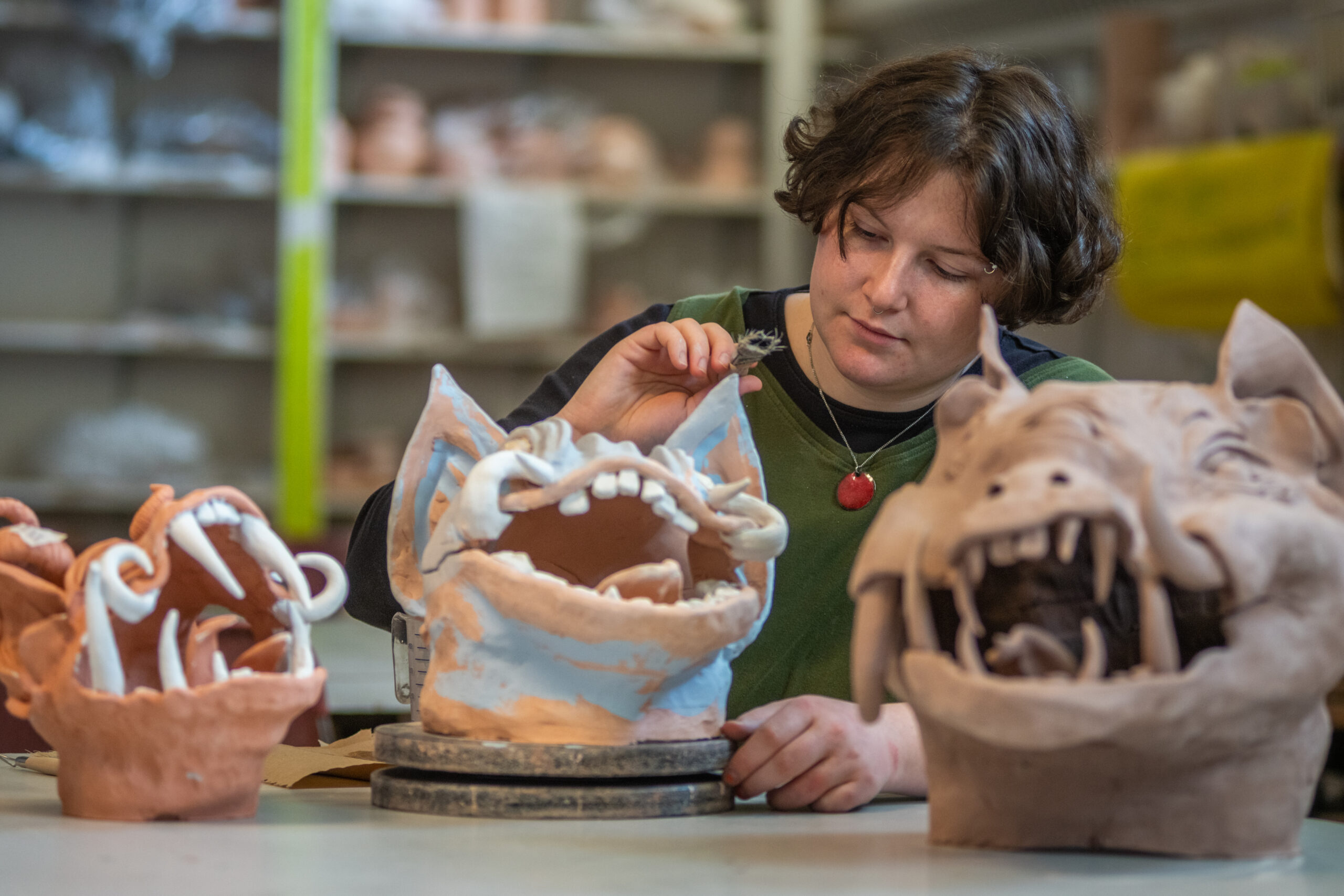 Brynn Keevil '23 created clay gargoyle heads in Clark's craft studio.