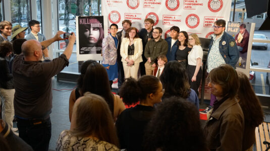 Students pose for a photo at the noir class's film debut.