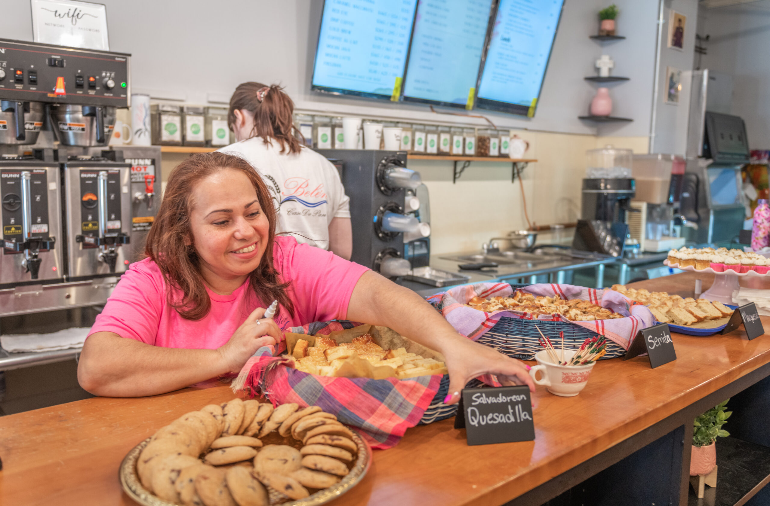 Zaida Melendez puts out cookies at Belen's Bakery