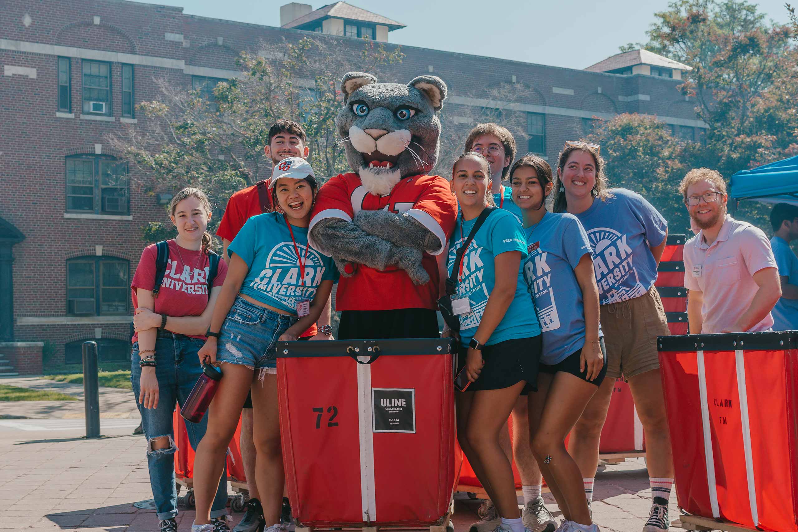 the cougar mascot posing with students