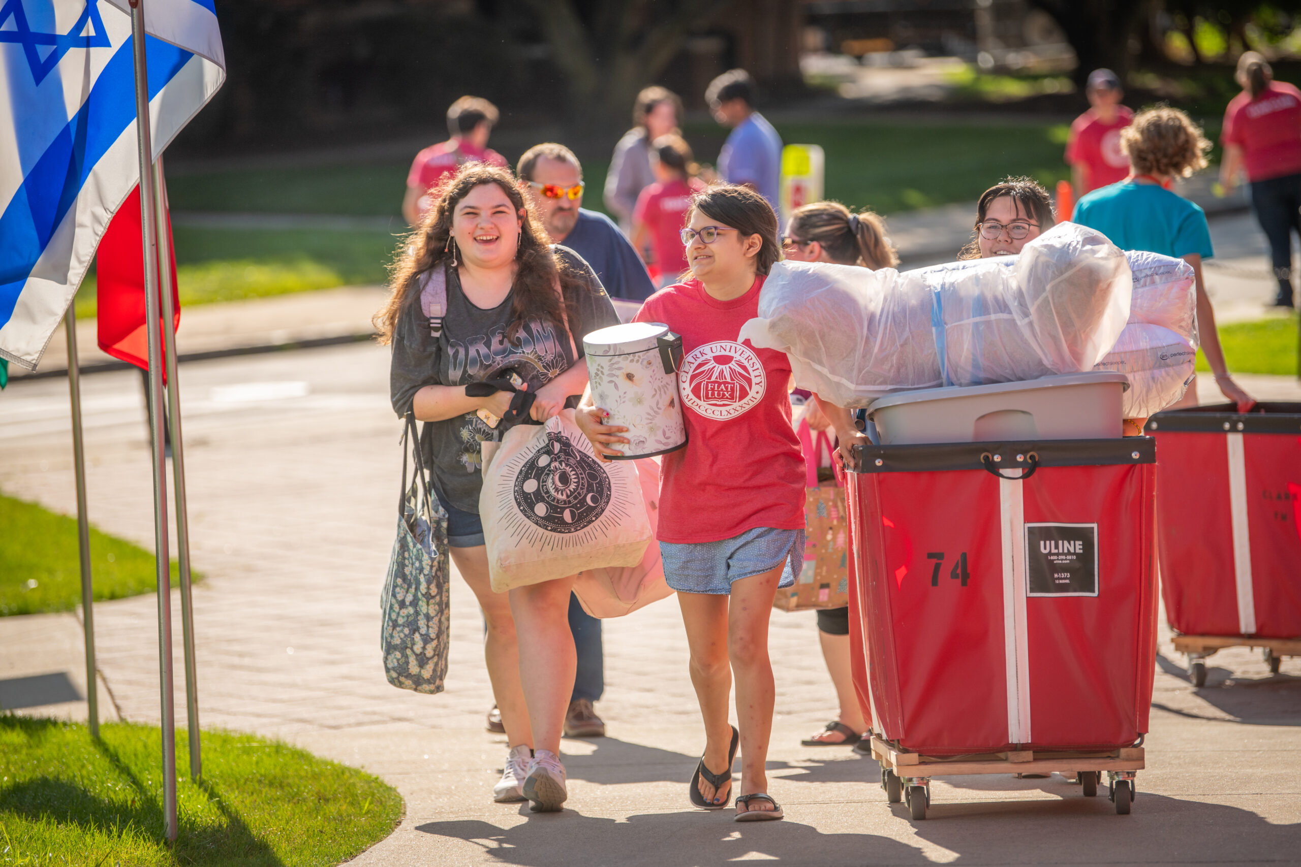 Students roll red bin on campus