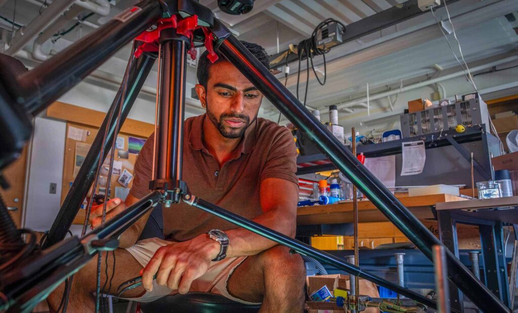 Balaram Desai '24 works in the Kudrolli Physics Lab on a robotic experiment.