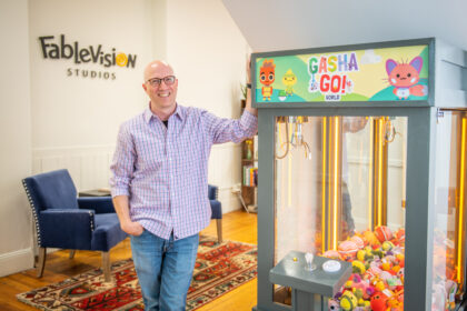 Gary Goldberger, president of Fablevision, with a claw machine game.