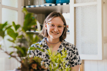 Student posed with plant