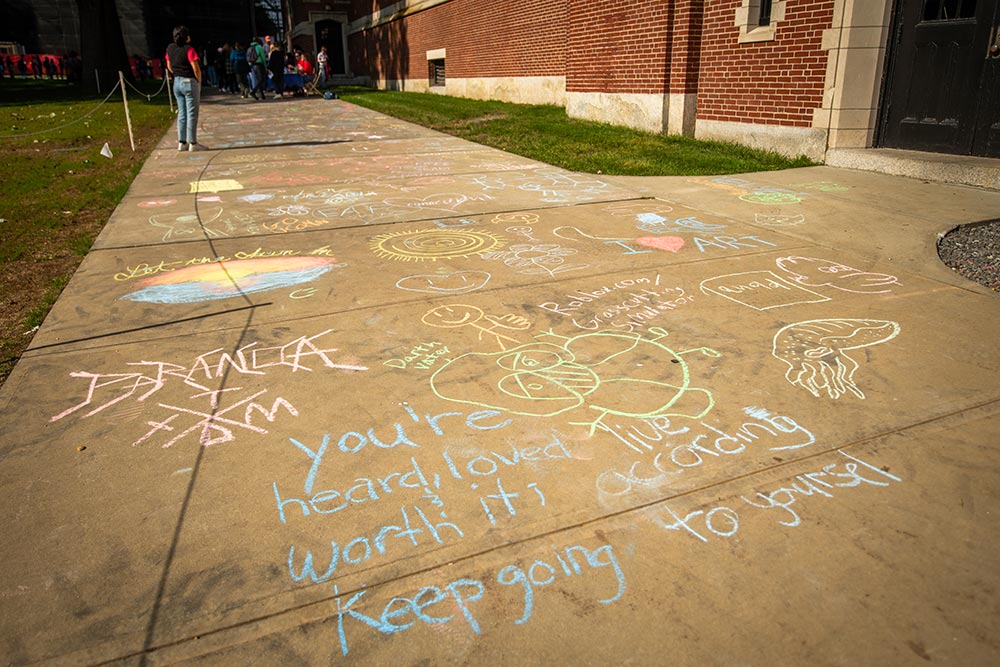 Messages written in chalk on Atwood Plaza during #FreshCheckDay, Clark University